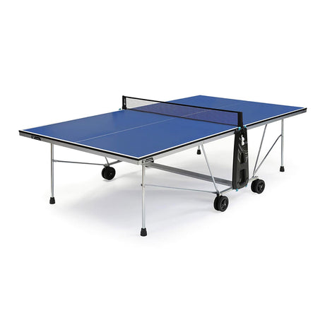 A blue Cornilleau indoor ping pong table with a net, wheels, and a storage bag.